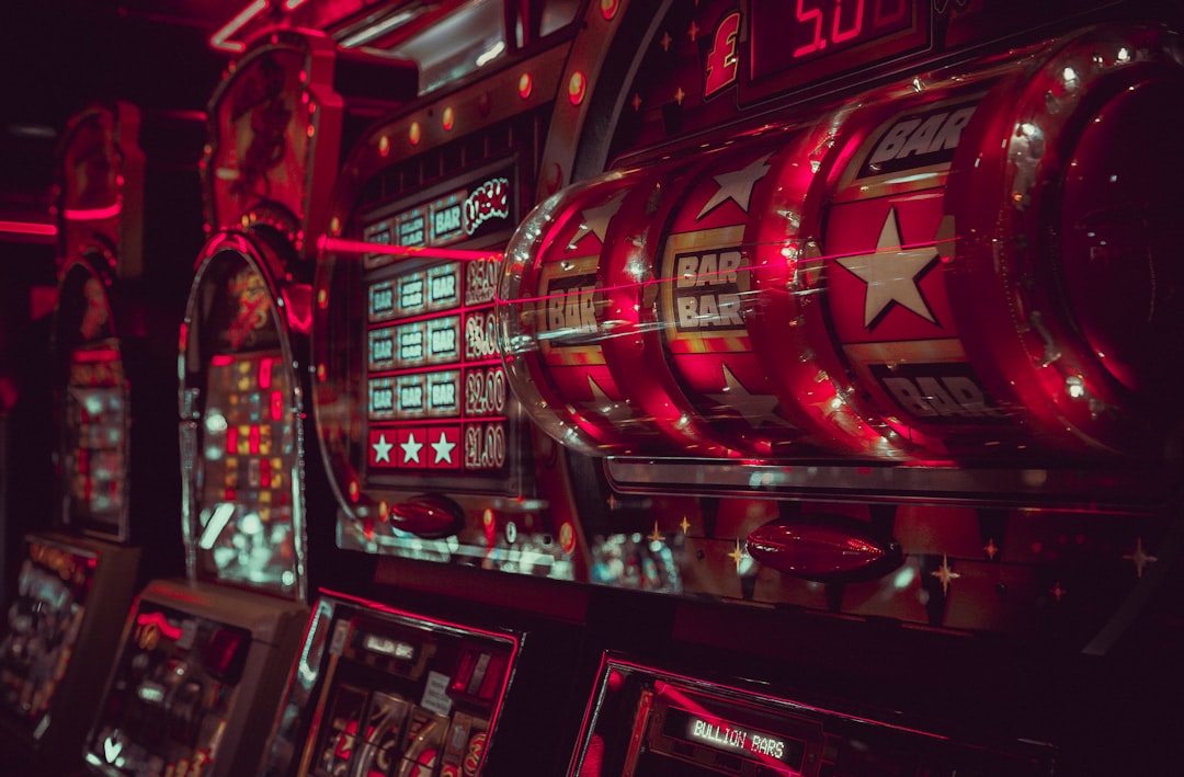 Close-up of vintage slot machines with vibrant red lighting in a casino